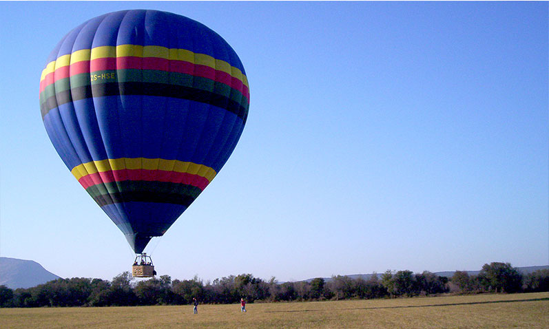 A hot air balloon coming in to land after a successful flight.